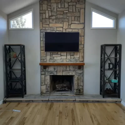 tv mounted over a stone fireplace