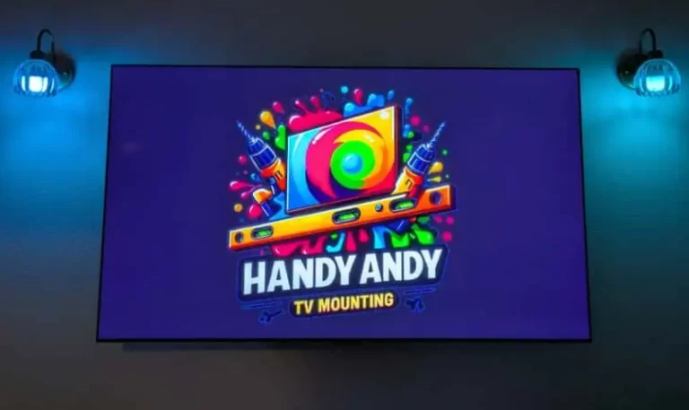 tv mounted on wall in austin with logo of handy andy tv mounting on the screen, green lights behind the tv.