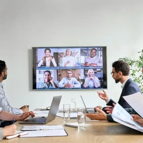 Professional office staff looking at tv mounted on wall